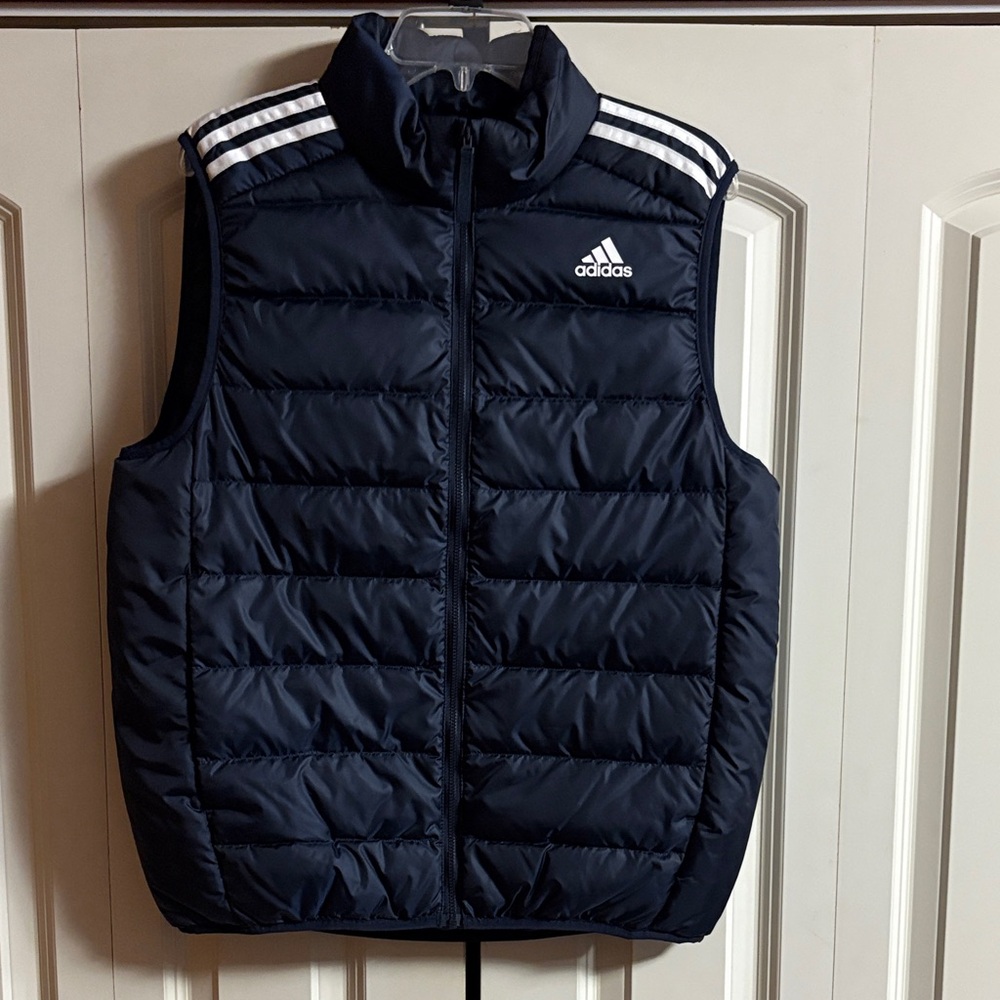 Adidas Dark Blue Puffer Vest with White Accents and side slide in pockets.